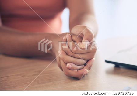Anxiety, stress and hands with worry on table in workplace for thinking, contemplation and making decision. Mental health, depression and stressed black woman employee with hand together on desk Anxiety, stress and hands with worry on table in workplace for thinking, contemplation and making decision. Mental health, depression and stressed black woman employee with hand together on desk 129720736