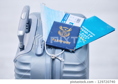 Covid, passport and suitcase for travel compliance, policy and documents in global, airport or visa information background. Corona, virus or covid 19 brochure with identity document, visa and luggage Covid, passport and suitcase for travel compliance, policy and documents in global, airport or visa information background. Corona, virus or covid 19 brochure with identity document, visa and luggage 129720740