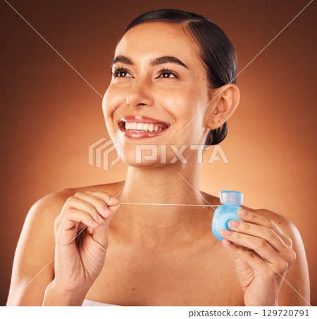 Teeth, floss and woman in studio for dental, health and mouth care, fresh and happy on orange background mockup. Girl, model and flossing for gum, wellness and tooth protection, breath and hygiene 129720791