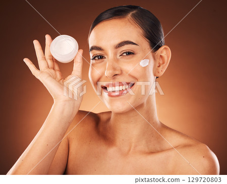 Cream, skincare and beauty woman in studio portrait for cosmetics product promotion, marketing and advertising. Model headshot or face for skin care serum glow or shine results in dermatology mockup 129720803