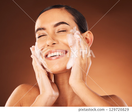 Skincare, hands and foam on face for cleaning with smile, happiness and spa wellness. Facial wash, luxury cosmetics therapy and self care with soap for beauty, dermatology grooming and cosmetology Skincare, hands and foam on face for cleaning with smile, happiness and spa wellness. Facial wash, luxury cosmetics therapy and self care with soap for beauty, dermatology grooming and cosmetology 129720829