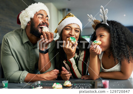 Family, christmas and eating cookies together after baking and cooking for bonding and learning. Bake, cook and sweet biscuit dessert with a mother, father and daughter enjoying food snack 129720847