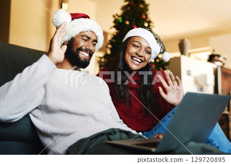 Video call, laptop and Christmas couple on sofa with hello wave for global, international or virtual communication with friends or family. Happy black people on zoom call for holiday celebration chat 129720895