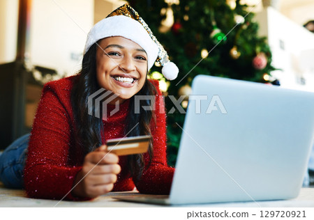 Woman, christmas and online shopping, credit card and laptop for payment, buy and portrait on festive holiday in home. Xmas, happiness and portrait of female and internet banking, tech and ecommerce Woman, christmas and online shopping, credit card and laptop for payment, buy and portrait on festive holiday in home. Xmas, happiness and portrait of female and internet banking, tech and ecommerce 129720921