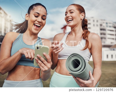 Yoga, fitness and phone with woman friends laughing at a meme in the park together during exercise. Pilates, social media and training with a female and friend joking outside on a field for a workout Yoga, fitness and phone with woman friends laughing at a meme in the park together during exercise. Pilates, social media and training with a female and friend joking outside on a field for a workout 129720976