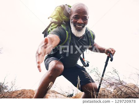 Hiking, help and portrait of senior man reaching hand during hike, fitness and cardio in nature on light background. Helping, hands and face of elderly guy offering support while trekking in a forest Hiking, help and portrait of senior man reaching hand during hike, fitness and cardio in nature on light background. Helping, hands and face of elderly guy offering support while trekking in a forest 129720978