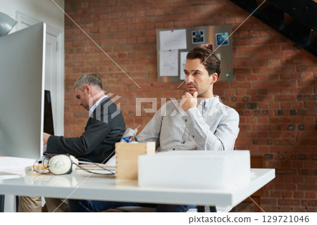 Young businessman, office employee at desk and man thinking of strategy, business solution and marketing idea in advertising agency. Corporate consulting firm, CRM consultant and company professional 129721046