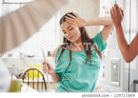 Dance, cooking and friends in a kitchen for breakfast, morning food and celebration at a sleepover. Music, playful and woman dancing with people in a house while preparing lunch or dinner together 129721069
