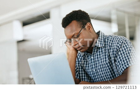 Burnout, depression and black man at work laptop with deadline, email and report at engineer workplace. Fatigue, tired and thinking engineering employee unhappy working at office with problem. 129721113
