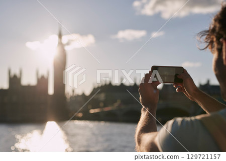 Man photograph Big Ben on phone in London, traveling and tourism, holiday sightseeing and famous historic landmark, buildings and vacation. Tourist, mobile pictures and clock tower in England city Man photograph Big Ben on phone in London, traveling and tourism, holiday sightseeing and famous historic landmark, buildings and vacation. Tourist, mobile pictures and clock tower in England city 129721157