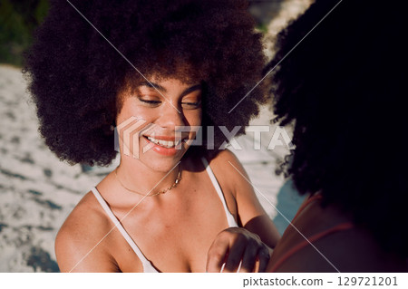Sunscreen, skincare and black woman at a beach with friends applying beauty cosmetics on back in Hawaii. Women, relax or happy African girl helping a person with spf protection cream or lotion at sea 129721201