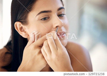 Grooming, nose tweezers and beauty care of a woman doing skincare and hair removal cleaning. Young person face doing health, facial and hair wellness for cosmetic dermatology treatment 129721238