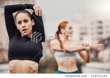 Exercise, friends and women in city stretching arms for outdoor workout on bridge or road for health and wellness. Sports, motivation and fitness mindset, urban training and people stretch together. 129721241