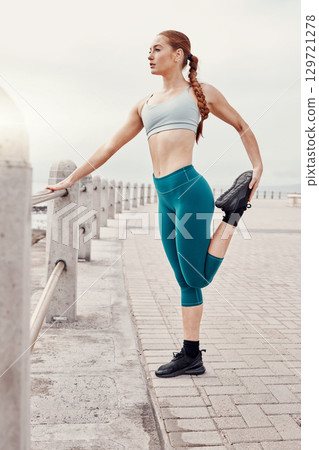 Woman stretching, legs and muscle by ocean at workout for performance, fitness and balance in morning. Young gen z irl, outdoor warm up and start training at beach for wellness, health and exercise 129721278