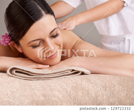 Spa, luxury and woman relax, happy and enjoy massage for holiday, peaceful and skincare. Zen, young female and lady enjoy healthy, break and bare with smile, calm or vacation for wellness and beauty. 129721332
