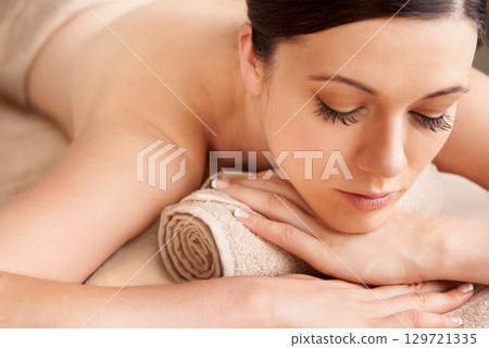 Spa, woman and relax for massage, wellness and luxury for health, calm and lying on table. Skincare, female and girl bare for body treatment and natural beauty for detox, peaceful or holiday 129721335