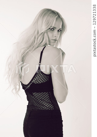 Black and white, fashion and portrait of woman in studio isolated on a background. Beauty, aesthetic and confident female model from Canada posing in stylish, edgy or designer brand apparel or outfit Black and white, fashion and portrait of woman in studio isolated on a background. Beauty, aesthetic and confident female model from Canada posing in stylish, edgy or designer brand apparel or outfit 129721338