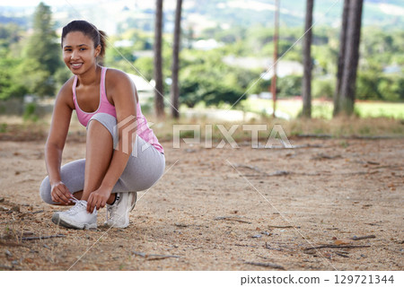Fitness, nature and woman tie shoes in forest ready to start hiking, running and training for wellness. Sports, performance and portrait of black woman tying lace of sneakers for exercise in woods Fitness, nature and woman tie shoes in forest ready to start hiking, running and training for wellness. Sports, performance and portrait of black woman tying lace of sneakers for exercise in woods 129721344