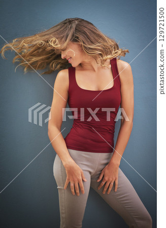 Young woman, hair throw and dance being happy, confident and relax with blue studio background. Female, healthy girl or hair style for natural beauty, smile or happiness for dancing, silly or freedom Young woman, hair throw and dance being happy, confident and relax with blue studio background. Female, healthy girl or hair style for natural beauty, smile or happiness for dancing, silly or freedom 129721500
