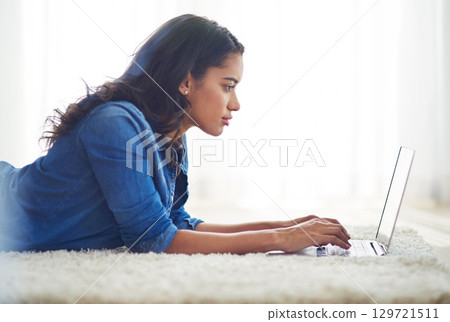 Floor, laptop and relax with a woman blogger or freelance worker doing remote work from home while lying. Computer, email and technology with a young female online working on her carpet in a house Floor, laptop and relax with a woman blogger or freelance worker doing remote work from home while lying. Computer, email and technology with a young female online working on her carpet in a house 129721511