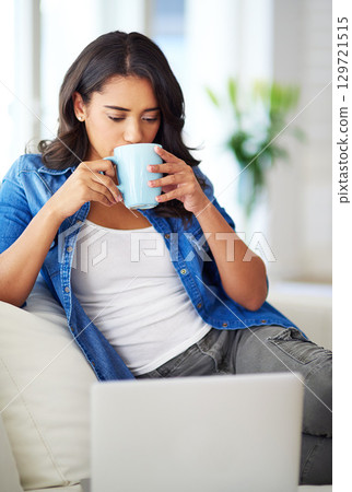 Woman, laptop and relax on sofa with coffee for morning routine, working online or read social media communications on tech. Drink tea, peace on couch and streaming news or web blog on computer Woman, laptop and relax on sofa with coffee for morning routine, working online or read social media communications on tech. Drink tea, peace on couch and streaming news or web blog on computer 129721515