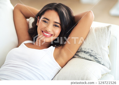 Woman, portrait and relax on sofa in house, home or hotel living room in holiday break, Portugal vacation and self care. Smile, happy and person lying with hands behind head in hospitality apartment Woman, portrait and relax on sofa in house, home or hotel living room in holiday break, Portugal vacation and self care. Smile, happy and person lying with hands behind head in hospitality apartment 129721526