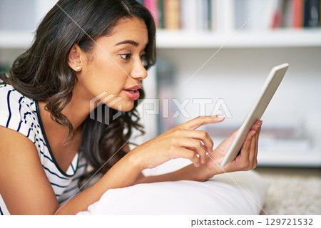 Woman, tablet and technology to relax at home with finger to touch for communication, social media and mobile app for video call. Female with technology for education, learning and streaming online Woman, tablet and technology to relax at home with finger to touch for communication, social media and mobile app for video call. Female with technology for education, learning and streaming online 129721532