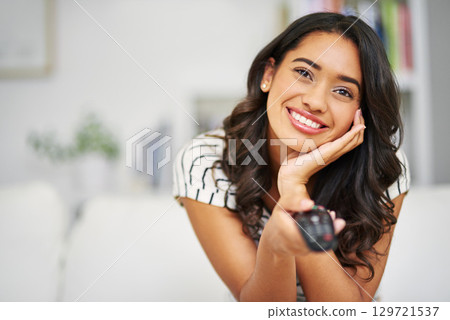 Movie, happy and woman watching tv to relax with freedom on a weekend a home with an online subscription. Smile, television and excited young girl enjoys streaming a tv show, film or movies on remote 129721537