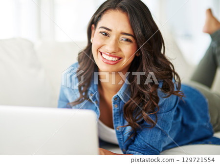 Relax, laptop and portrait of woman on sofa for research, social networking and blog app. Internet, technology and website with girl in living room at home for content, online and connectivity 129721554