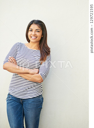 Fashion, portrait and woman with arms crossed on wall with mock up space. Happy, smile and fashionable, cool and confident comic female from Brazil smiling, cheerful and excited for life with mockup. 129721595
