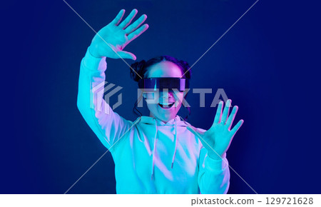Virtual reality glasses, wow and a woman with vr tech for futuristic gaming, cyber and 3d world. Gamer person excited with hands for ar, digital experience and cyberpunk ux dark background app 129721628