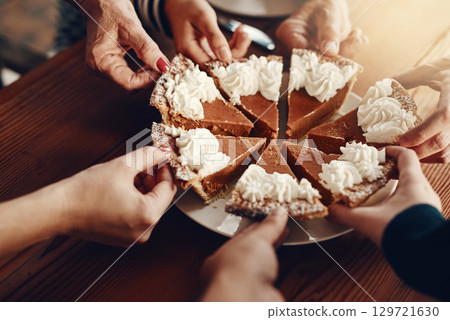 Cake, celebration and hands of family at a party for Christmas lunch together in a house. Food, sharing and friends with pie for dessert after Thanksgiving dinner during the holiday in a family home Cake, celebration and hands of family at a party for Christmas lunch together in a house. Food, sharing and friends with pie for dessert after Thanksgiving dinner during the holiday in a family home 129721630