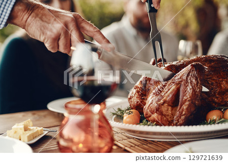 Man cut turkey, chicken and food for thanksgiving, christmas and family lunch, dinner table setting or party, celebration and meal in home. Hands, knife and carving meat, poultry and feast for dining Man cut turkey, chicken and food for thanksgiving, christmas and family lunch, dinner table setting or party, celebration and meal in home. Hands, knife and carving meat, poultry and feast for dining 129721639