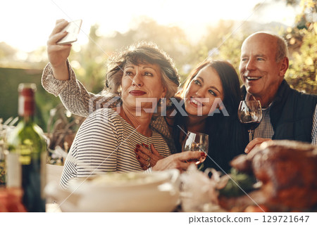 Family, phone selfie and happy thanksgiving, lunch and happy with wine, glass and social media photo in home. Senior mother, father and daughter smile, love and together for picture, alcohol and care 129721647