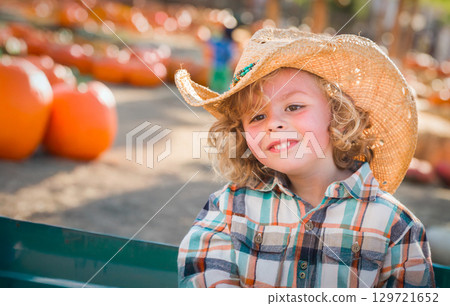 Cute Young Boy Wearing Cowboy Hat at Pumpkin Patch Farm. 129721652