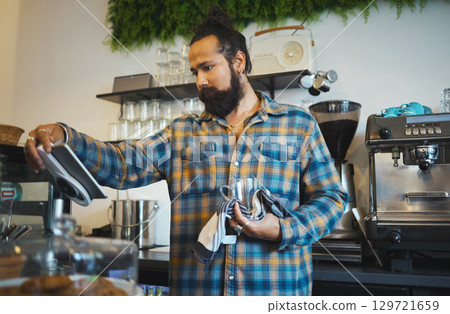 Coffee, tablet and barista reading orders, checklist or inventory online while working at a cafe. Service, morning and man with technology ordering supplies, product and connection with supplier 129721659