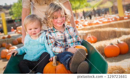 Young Children Enjoying a Sunny Fall Day at the Pumpkin Patch. 129721681