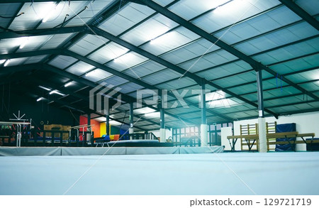 Interior hall of empty gymnastics arena, building and floor for training, professional performance or class. Backgrounds, studio space and room for sports, workout or indoor athletic practice 129721719