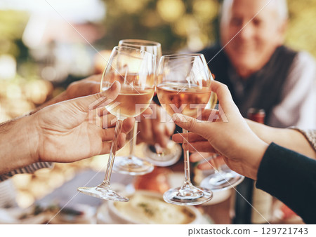 Hands, glass and cheers with a group of people drinking alcohol together outdoor in celebration of the festive season. Party, wine and drink with a man and woman family doing cheers to tradition Hands, glass and cheers with a group of people drinking alcohol together outdoor in celebration of the festive season. Party, wine and drink with a man and woman family doing cheers to tradition 129721743