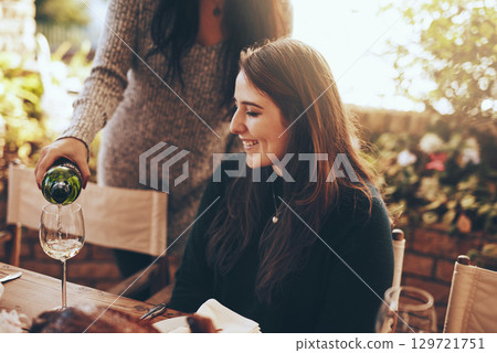 Dinner party, nature and pouring wine for woman sitting at table in restaurant for social event, party and celebration. Festive, alcohol and girl enjoying vacation, holiday and weekend at vineyard Dinner party, nature and pouring wine for woman sitting at table in restaurant for social event, party and celebration. Festive, alcohol and girl enjoying vacation, holiday and weekend at vineyard 129721751