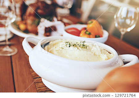 Food, table and dinner with party to celebrate holiday or anniversary with mashed potato closeup and nutrition. Healthy meal, feast for Christmas or Thanksgiving with celebration and vegetable zoom. 129721764