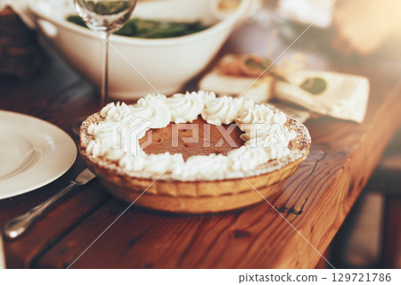 Pumpkin pie, food and table set for lunch on dinning table in home. Fine dining, cake or pastry for buffet, brunch or thanksgiving party, festive celebration or luxury dessert, meal or dish in house 129721786