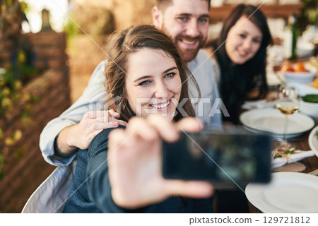 Friends, selfie and dinner with party and celebration, woman holding smartphone for photo and Christmas or Thanksgiving dinner party. Happy, celebrate and food, having meal together and smile. Friends, selfie and dinner with party and celebration, woman holding smartphone for photo and Christmas or Thanksgiving dinner party. Happy, celebrate and food, having meal together and smile. 129721812
