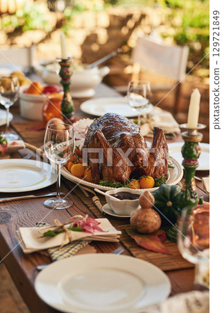 Thanksgiving, food and turkey table for gratitude, thanks and grace holiday lunch outside. Roast, vacation and festive outdoor dining meal with colorful decoration for USA celebration. Thanksgiving, food and turkey table for gratitude, thanks and grace holiday lunch outside. Roast, vacation and festive outdoor dining meal with colorful decoration for USA celebration. 129721849