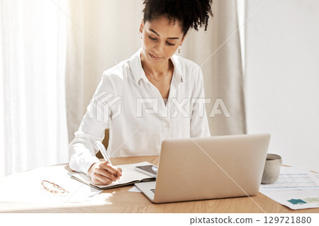 Fintech, budget and woman writing at laptop with notebook at table with finance or tax documents. Savings, strategy and planning, black woman working on payment plan for online financial investment. Fintech, budget and woman writing at laptop with notebook at table with finance or tax documents. Savings, strategy and planning, black woman working on payment plan for online financial investment. 129721880