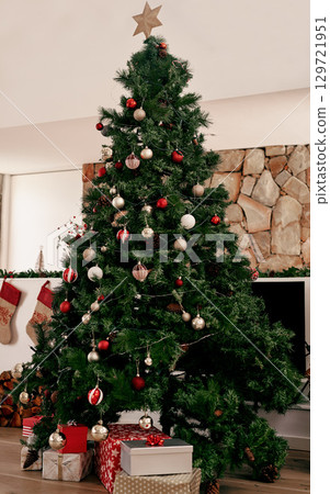 Christmas, tree with gifts and decorations for festive season celebration event in living room for magic holiday tradition. Xmas presents, Christmas tree ornaments and December winter vacation home 129721951