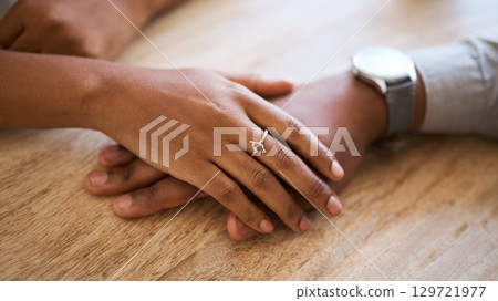 Couple, hands and support with love and trust zoom against wood table, hand touching with care and comfort. Helping hand, relax and commitment with relationship partnership and solidarity together. Couple, hands and support with love and trust zoom against wood table, hand touching with care and comfort. Helping hand, relax and commitment with relationship partnership and solidarity together. 129721977