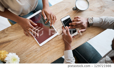 Hands, tablet and phone with a coffee shop business team working together online closeup from above. Marketing, ecommerce and remote work with a man and woman employee at work in an internet cafe 129721986