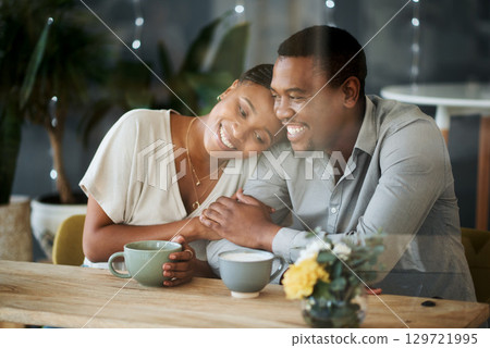 Cafe, love and happy black couple on a date hugging, talking or holding hands while drinking coffee or tea. Happiness, relaxing and romantic black woman enjoys quality time with African partner 129721995