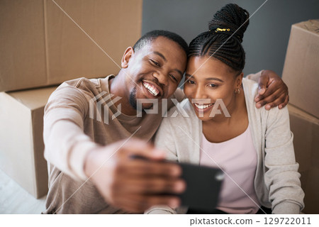 Phone, couple and selfie while moving in to home, real estate or apartment, happy and proud on a floor. New house, property and man with woman on a living floor for picture, moment and bonding 129722011